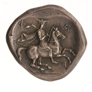 Reverse of a silver drachma coin from Pharsalus in Thessaly, showing a Thessalian horseman in chiton, chlamys, and petasus. Photo: ANS 1967.152.239. American Numismatic Society.