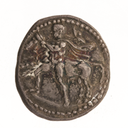 Obverse of a silver drachma from Larissa in Thessaly, showing a wrestler, nude except for chlamys and petasus, subduing a bull by its horns. Photo: ANS 1967.152.234. American Numismatic Society.