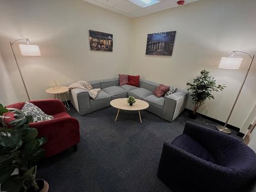 A living room with a couch and a coffee table Description automatically generated with low confidence
