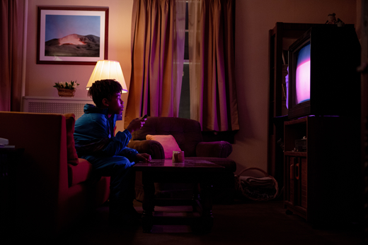 Younger Owen (Ian Foreman) watches the glow in I Saw the TV Glow (dir. Jane Schoenbrun, 2024). Courtesy © A24.