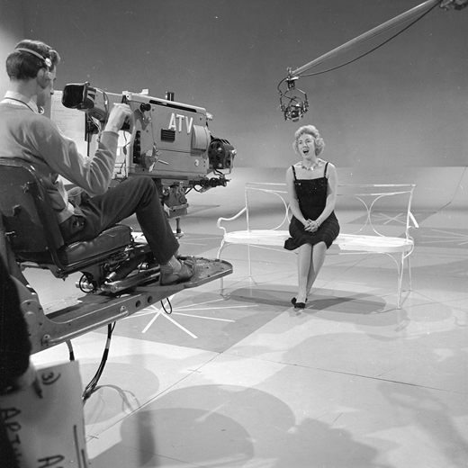 Vera Lynn on the ATV (Associated-Rediffusion Television) set “at Wood Green Empire or at the Palladium” in the late 1950s. ATV held the ITV franchise in the London area. Photograph by Harry Hammond. © Harry Hammond / Victoria and Albert Museum, London. Used by permission.