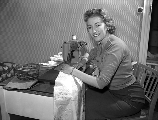 Vera Lynn at her sewing machine, in the BBC television series At Home, ca. March 1957. PA Images / Alamy Stock Photo. Used by permission.