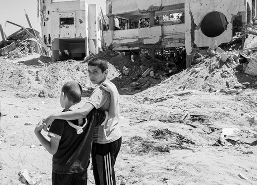 Young Gazans in front of their house in the Shuja‘iya neighborhood destroyed in Operation Protective Edge. (2014, photo by the author)
