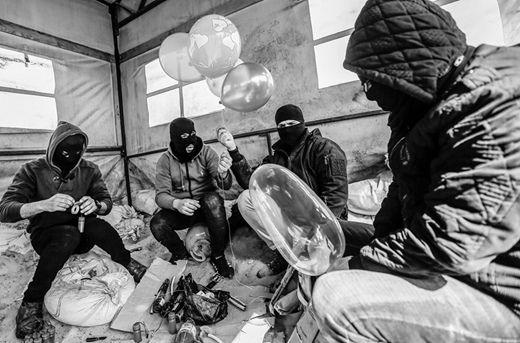 Masked Palestinians inflate balloons and assemble incendiary devices in al-Bureij refugee camp close to the Gaza-Israel perimeter fence. The use of such devices surged after the Trump administration's 28 January announcement of its Middle East “peace plan.” (10 February, Mahmud Hams/AFP via Getty Images)