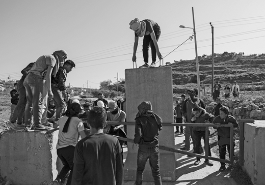 Palestinians from Dayr Nizam struggle to remove cement blocks placed by the Israeli military at the village entrance. The Israeli authorities erected the barriers after widespread Palestinian protests against the Trump administration's proposed Middle East “peace plan.” Although the villagers were eventually able to remove the blocks, Israeli soldiers replaced them two days later. (15 February, Abbas Momani/AFP via Getty Images)