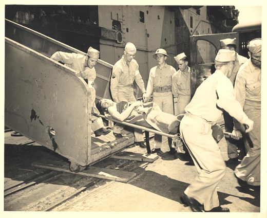 “The wounded arrive by ship from action in the Pacific for treatment at Pearl Harbor Navy Yard Hospital: being carried down the gangplank.” Source: Series: Box 4 FF 7, PHNY: Return of the wounded, departure of troops Undated. Cat. no. PHNY 142, Robert F. Walden Collection (1936–1991), University of Hawai‘i at Mānoa Library.